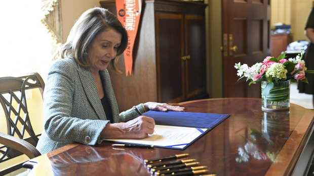 House Speaker Nancy Pelosi signs the disapproval resolution that had blocked Trump's national emergency declaration.