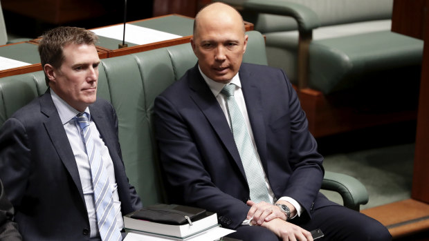 Backbencher and leadership aspirant Peter Dutton takes a seat next to Attorney-General Christian Porter during a division on Thursday.