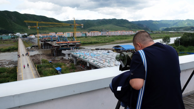 A Chinese tourist looks at North Korea from the Tumen side of the border.