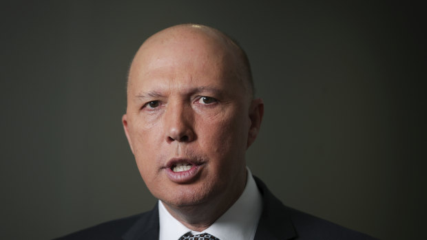 Minister for Home Affairs Peter Dutton addresses the media during a doorstop interview in the press gallery at Parliament House in Canberra. 
