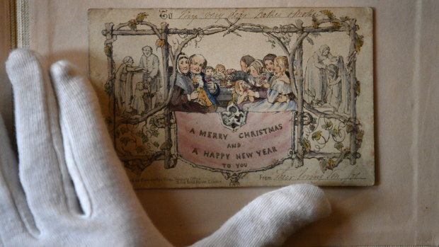 The world's first printed Christmas card is displayed at the Dickens Museum in London. The hand-coloured lithograph card was produced in 1843 and sold for one shilling.