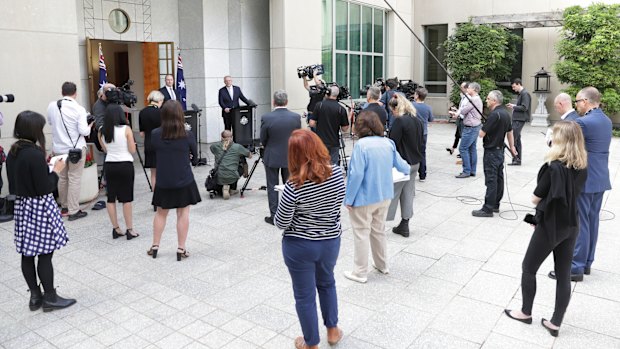 Social distance ... Neville Power,chair of the new National COVID-19 Co-ordination Commission, and Prime Minister Scott Morrison at a press conference at Parliament House on  Wednesday. 