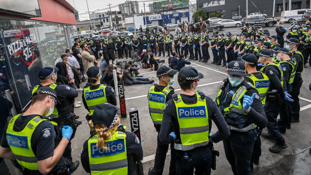 Protesters are surrounded by police at the end of the protest.