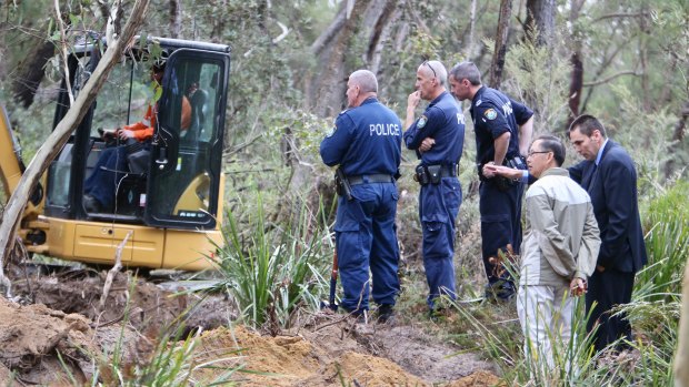 Police and Quanne’s father search in bushland in 2017.