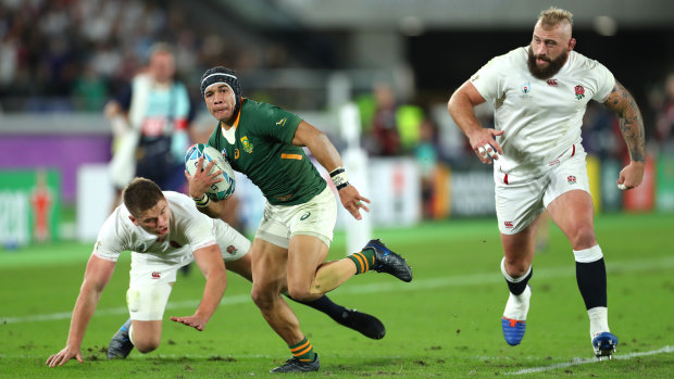 Cheslin Kolbe breaks through the tackle of Owen Farrell of England to score.