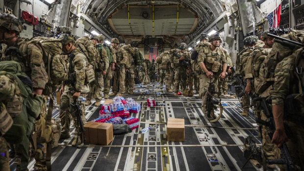 Members of the 82nd Airborne Division, deplane a US Air Force C-17 Globemaster III aircraft after touching down at Ali Al Saleem Air Base, Kuwait. 