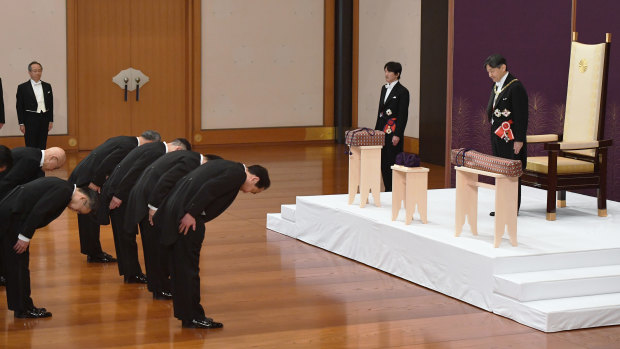 Japan's new Emperor Naruhito stands after receiving the Imperial regalia of sword and jewel as proof of succession  on Tuesday.