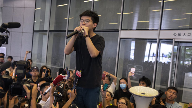 Joshua Wong addresses protesters gathered at the Legislative Council building.