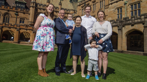Michael Spence has seven children, with another on the way. He's pictured here holding son Hugo, with his wife Jenny, centre, and children, from left, Felicity, James, Theodore and Lucinda Spence.