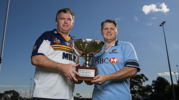 It's on: Owen Finegan and Matt Dunning hold the Dan Vickerman Cup ahead of this weekend's derby between the Waratahs and Brumbies. 