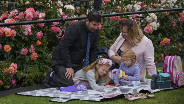 The Wogandt family travelled down from Queensland. Lily, 6, and Baylie, 3, with their parents Ken and Katie enjoyed a calm moment at Flemington before the rain pelted down. 