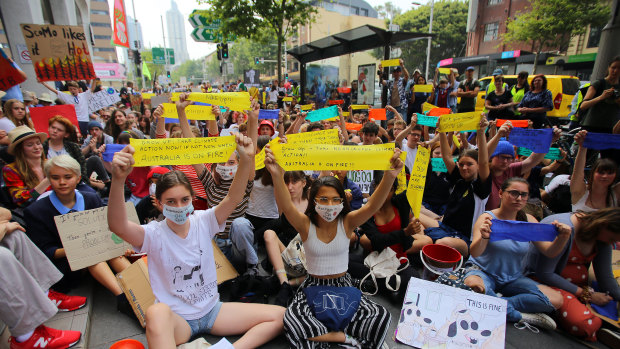 Student activists from School Strike for Climate Australia (SS4C) hold a 'Solidarity Sit-down' outside the office of the Liberal Party in Sydney, on Friday.