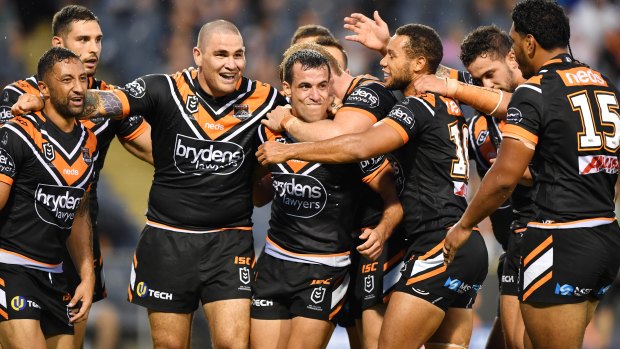 Better together: Corey Thompson celebrates a try with his Tigers teammates.