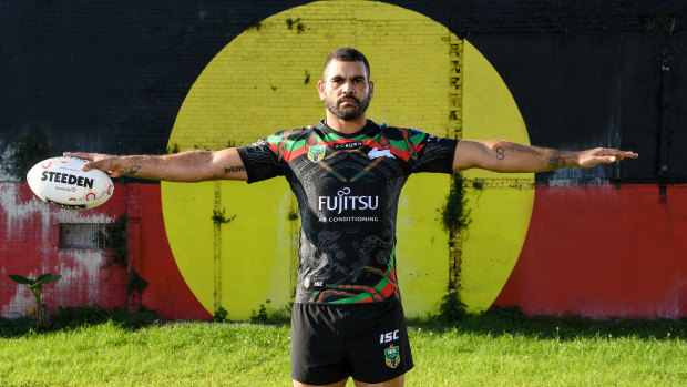 True colours: Greg Inglis poses against an Aboriginal flag in Redfern for the NRL's Indigenous round. 