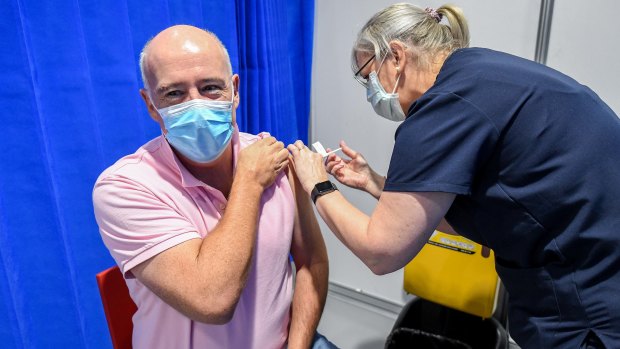 A man gets the AstraZeneca vaccine at the  Melbourne Convention and Exhibition Centre.