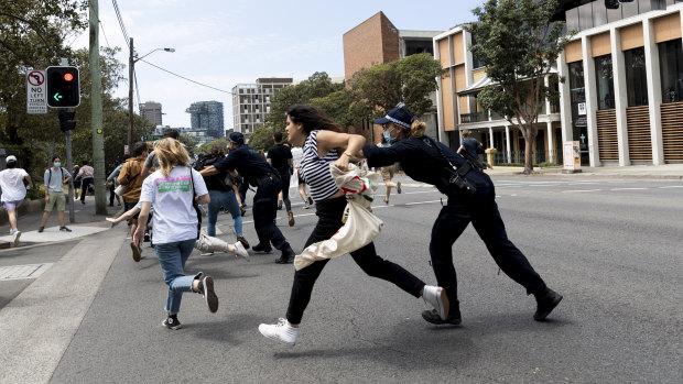 Police clear protesting students from the road at Sydney University.
