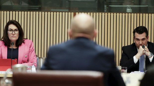 Senators Deborah O'Neill and Michael Sukkar listen as Tony Alford, former chief executive of Retail Food Group, appears before the parliamentary inquiry into franchising.  