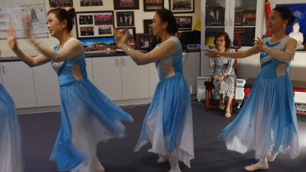 Mrs Zhang watches on as the dance group perform their moves.