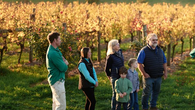 Winemaker Nick Farr, far left, with family and friends in the vineyard.