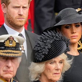 King Charles III, Camilla, the Queen Consort, Prince Harry and Meghan, Duchess of Sussex watch as the coffin of Queen Elizabeth II is placed into the hearse following the state funeral service in Westminster Abbey  last year.