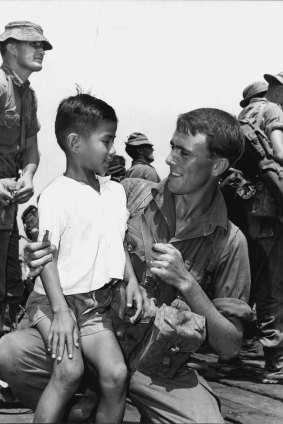 Mohammed Majivi, 8, has a sunny farewell smile for Private Peter Harding, of Oakleigh, Victoria, before the 4th Battalion left Borneo.