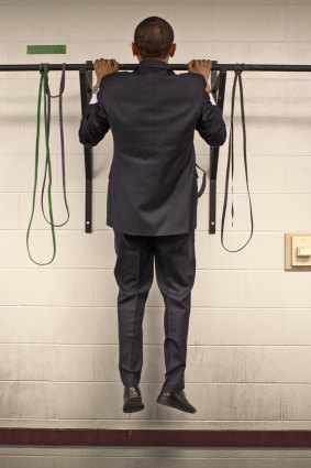 Before this photo is taken, two staffers pass the bar and do two pull-ups each. Not to be outdone, Obama does three with ease, then walks out to make a speech.