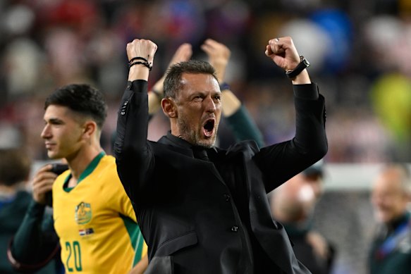 Tony Popovic celebrates after Australia secured their spot in the last 32 of the World Cup.