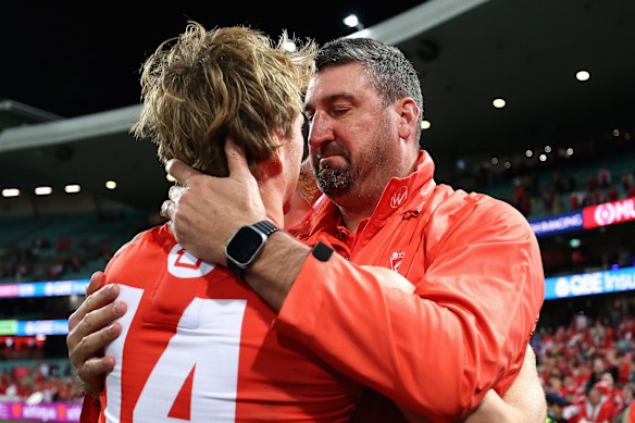 Callum Mills of the Swans embraces head coach Dean Cox after the game. 