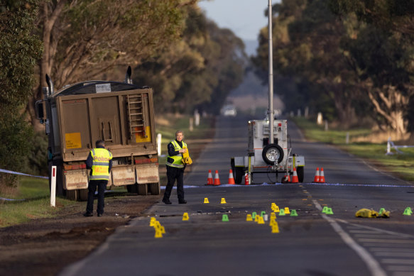 Police mark out evidence at the crash scene on Wednesday morning.