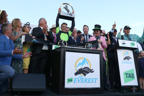 Sam Clipperton lifts the Everest trophy after Think About It’s victory at Randwick on Saturday. 