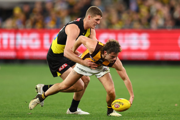 Nick Watson of the Hawks (R) is tackled.