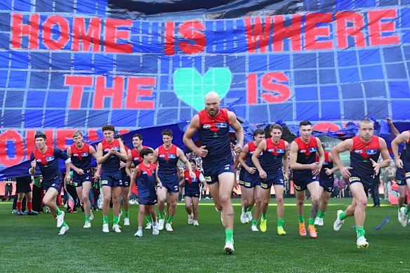 Melbourne captain Max Gawn leads the Demons on the field at the MCG.