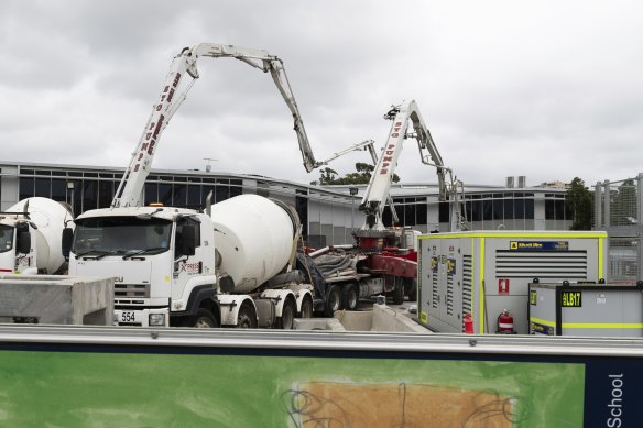 Workers fill in a huge sinkhole with cement in March last year to stabilise a two-storey building that teetered on the edge.