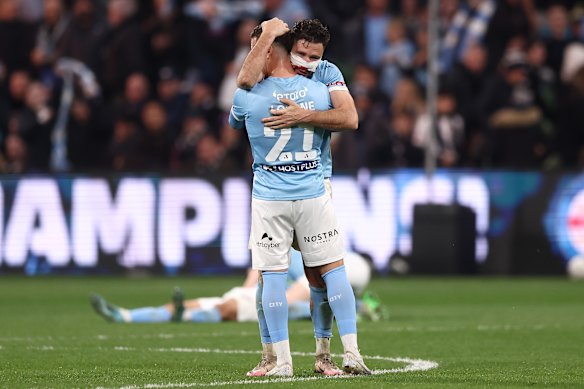 Mathew Leckie and Alessandro Lopane of the City celebrate.