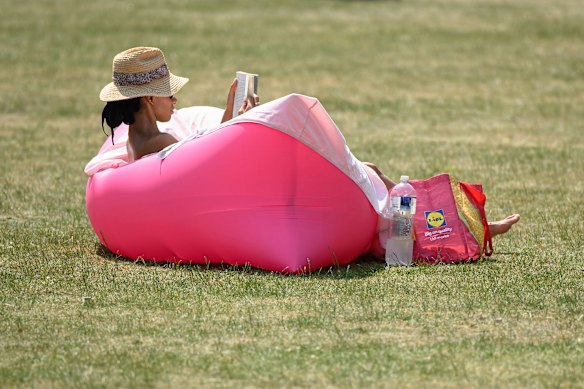 A sunbather enjoys the heat in St James’ Park.
