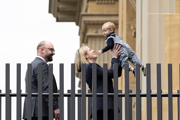 Wilson enters Parliament House on Tuesday with husband Aaron Lane and their son Patrick.