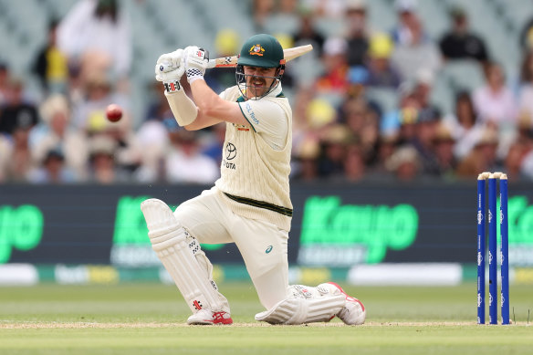 Travis Head carves a boundary on day two in Adelaide.