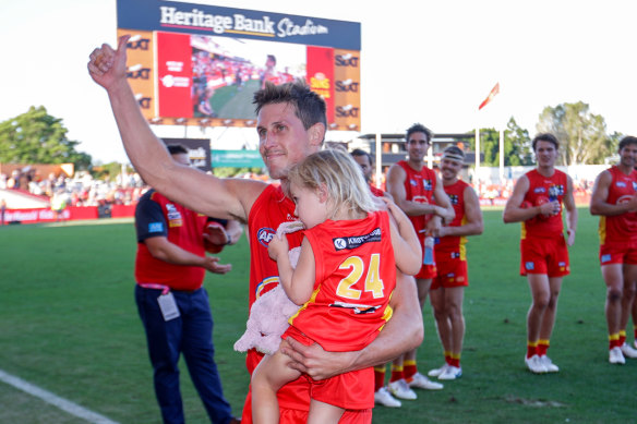 Gold Coast’s David Swallow leaves the ground victorious in his 200th AFL match for the club.