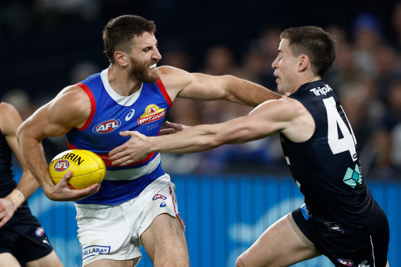 Marcus Bontempelli fends off Matthew Owies in round nine. 