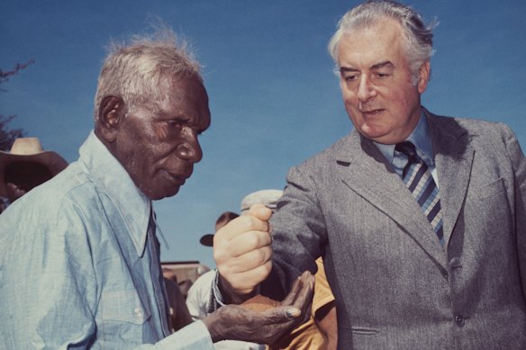 Then prime minister Gough Whitlam pours soil into the hand of traditional landowner Vincent Lingiari in 1975.