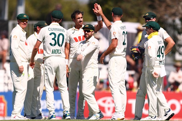 Mitchell Starc and the Australian cricket team celebrate in Mackay.