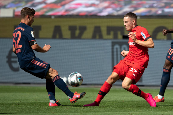 Florian Wirtz, right, in action against Bayern Munich. Wirtz became the youngest goalscorer in Bundesliga history with his 89th-minute strike.