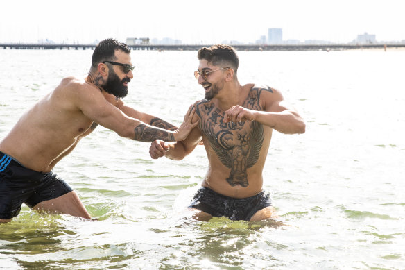David Gorrguis (left) and Volkan Akdogan cooling off in the water on Thursday.