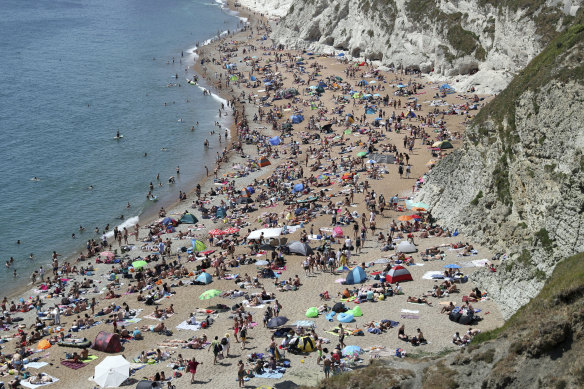 People on the beach near Lulworth in Dorset, England on Saturday.