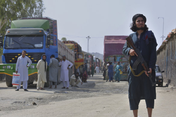 A Taliban fighter stands guard on Afghan side of the border at Torkham last year. 