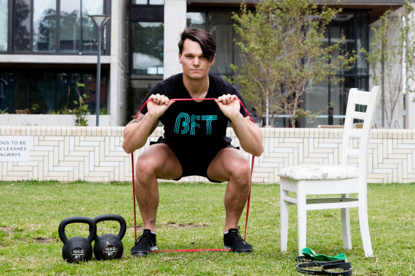 Fitness trainer Jeremy Tunkunas using some of his home equipment.
