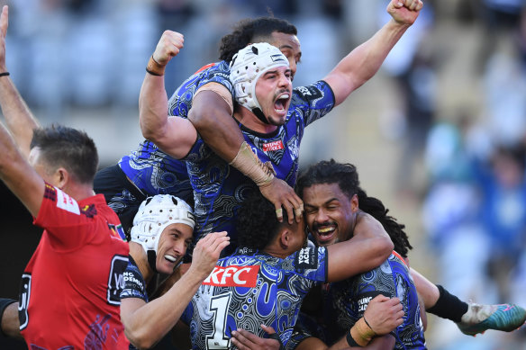 Reed Mahoney and his Bulldogs teammates celebrate Jayden Okunbor’s (bottom right) winning try.