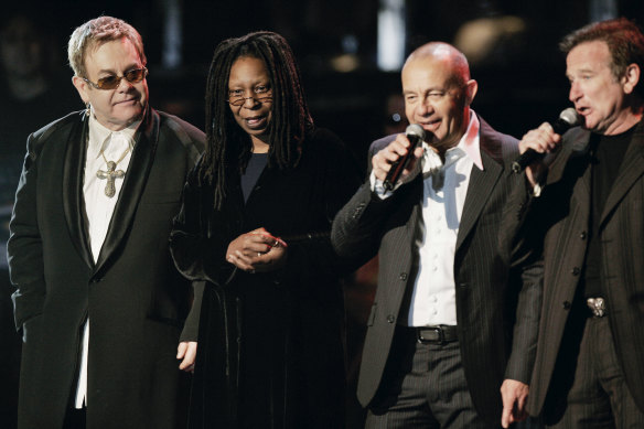 Elton John, Whoopi Goldberg. Bernie Taupin and Robin Williams:  “I was saddened immensely by Robin’s death. He was a thing of beauty in a cantankerous world,” Taupin writes.