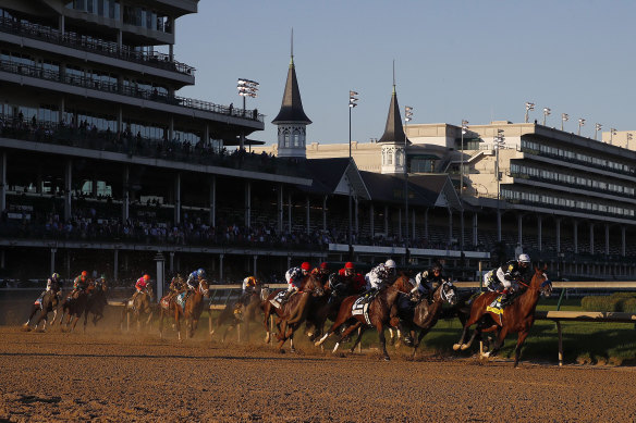 Authentic, with John Velazquez in the saddle, leads the Kentucky Derby field past the first turn en route to an  upset win at Churchill Downs.
