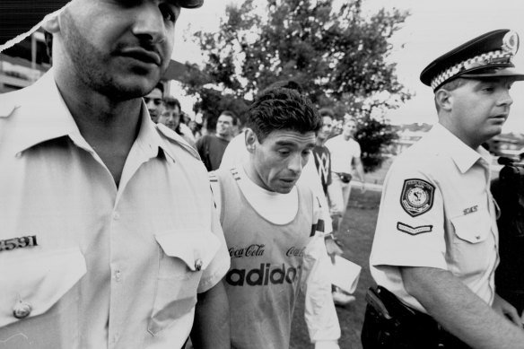 Diego Maradona is escorted off Wentworth Park after training with the Argentinian team in 1993.